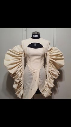 a white dress with ruffled sleeves on display