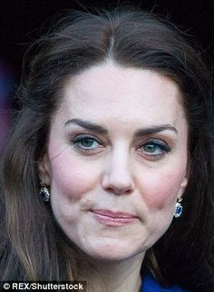 a close up of a person wearing earrings and a blue dress with long hair, looking at the camera