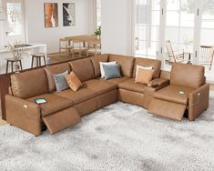 a living room with a large sectional couch and lots of pillows on the rugs