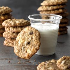 cookies and milk are on the table next to each other