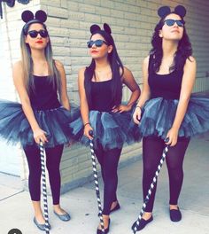 three girls dressed up as mickey mouse and minnie mouse ears, one with sunglasses on her head