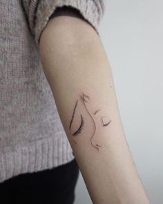 a woman's arm with a small tattoo on the left side of her arm