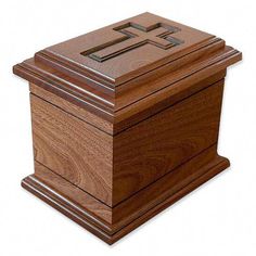 a wooden box with a cross on the front and sides, sitting on a white background