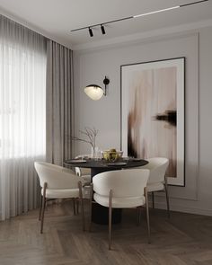 a dining room with white chairs and a black table in front of a painting on the wall