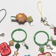 several different key chains with charms attached to them