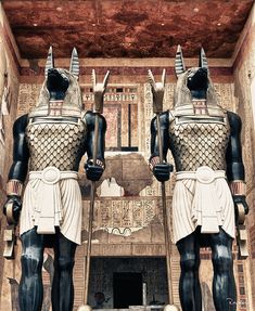 two egyptian statues standing next to each other