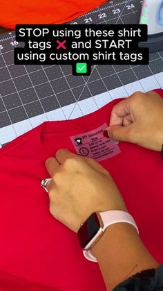 a person wearing a red shirt and using a smart watch on their wrist to measure the size of a t - shirt