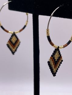 Handmade hoop earrings with diamond shaped dangle in black, brown, gold colors on steel hoops 1 inch wide and 1.75 long suitable for any gender, fashionable, versatile, lightweight suitable for everyday wear dress up or dress down. FREE SHIPPING Brown Beaded Hoop Earrings, Boho Drop Earrings, Handmade Hoop Earrings, Diamond Shape Earrings, Fancy Earrings, Vintage Style Rings, Beaded Hoop Earrings, Beaded Hoops, Sterling Silver Hoops