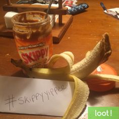 a jar of syrup next to a peeled banana and a sign that says skippy