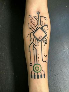 a person with a tattoo on their leg that has a circuit board in the middle