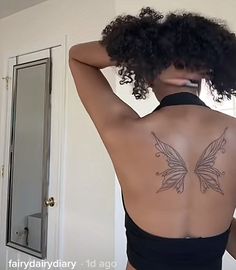 the back of a woman's body with a butterfly tattoo on her left side