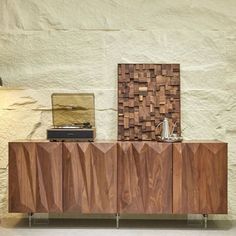 the sideboard is made out of wood and has a record player on top of it