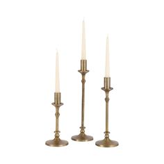 three brass candlesticks with white candles