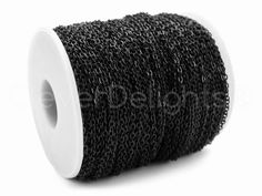 a spool of black chain on a white background