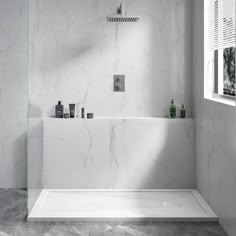 a bathroom with white marble walls and flooring, including a bathtub in the corner