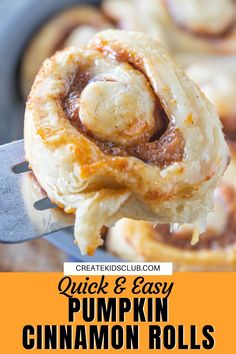 a close up of a cinnamon roll on a spatula with the words quick and easy pumpkin cinnamon rolls