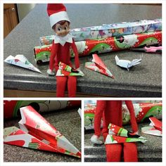 an elf is sitting on the counter next to origami airplanes and wrapping paper