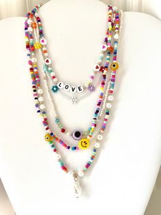 "Rainbow beaded necklace with freshwater pearls 16\" Beaded necklace with 3' extender Rainbow beaded necklace with \"LOVE\" beads is 14\" with 3\" extender Lobster claw clasp" White Beaded Pearl Charm Necklaces, Trendy White Beaded Charm Necklaces, Adjustable Pearl Necklace With Heart And Round Beads, White Beaded Charm Necklaces With Round Beads, White Charm Necklaces With Colorful Round Beads, Adjustable Pearl Necklace With Letter Beads, Bohemian Pearl Necklaces With Letter Beads, Bohemian Pearl Necklace With Letter Beads, Trendy White Pearl Necklace With Heart Beads