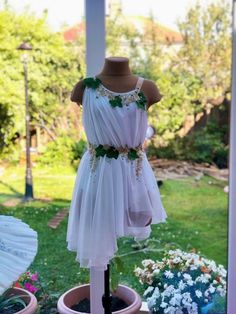 a white dress on display in front of a window