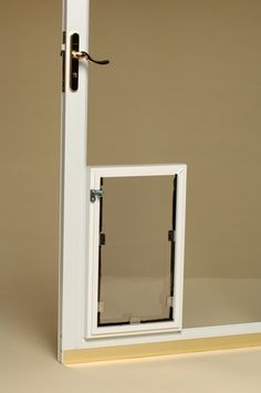 an open door with a window on the inside and outside, in front of a beige wall