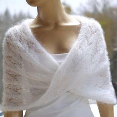 a mannequin is wearing a white shawl