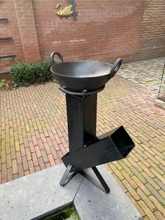 an outdoor bbq grill sitting on top of a sidewalk