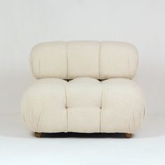 a white couch sitting on top of a wooden frame