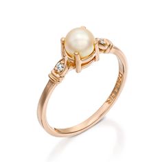 a pearl and diamond ring in yellow gold with diamonds on the sides, set against a white background