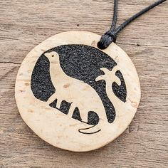 With this necklace Guatemalan artisans Fernando and David pay homage to the ancient dinosaurs. Within a circle of coconut shell the image of a charming diplodocus is carved by hand. The cutaway portions are filled with lava stone and resin for a striking contrast. This necklace adorns the wearer on an adjustable length of black nylon cord. Bags Pattern, Shoulder Bags Pattern, Coconut Shell, Stone Pendant Necklace, Wood Pendant, Lava Stone, Small Pendant, Black Nylon, Free Gift Wrapping