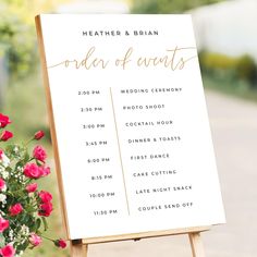 a wooden easer holding a sign that says order of events with flowers in the foreground