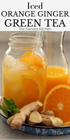 orange ginger green tea in a glass jar with sliced oranges and ginger on the side