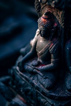 a statue of a buddha sitting on top of a table