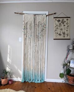 a living room with a window covered in beads and tassels on the curtains