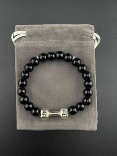 -Application: weighted bracelet length of 20CM elastic band with 8MM high-quality round Onyx stones, designed to relieve pressure, meditation, yoga, and essential oil diffusion. -This striking accessory features high-quality Black Onyx beads, exuding a rich, deep black hue that evokes a sense of power, sophistication, and confidence. -As a powerful grounding stone, it promotes emotional stability, mental clarity, and focus, while protecting negative energies and psychic attacks. -Black Onyx is a Adjustable Black Beaded Bracelets With Polished Beads, Black Onyx Beaded Bracelets With Polished Beads, Black Onyx 8mm Bead Jewelry, Black Onyx Jewelry With 8mm Beads, Black Onyx 8mm Beads Jewelry, Spiritual Black Beaded Bracelets, Elegant Black Jewelry With 8mm Beads, Black Spiritual Jewelry For Party, Spiritual Black Beads Bracelet