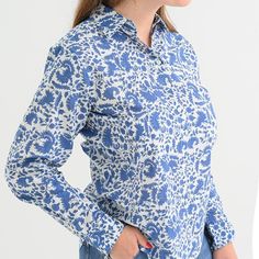 Cobalt blue flowers dance across our classic and versatile button down. Easy to dress up with a pair of white jeans and stiletto sandal, or perfect for casual everyday, with a pair of flats or flip-flops. Tidy up by tucking it in, or stay chilled by leaving it out. Blue Blouse With Button Cuffs For Spring, Fitted Indigo Summer Blouse, Fitted Indigo Blouse For Summer, Spring Indigo Button-up Tops, Summer Workwear Blouse In Indigo, Indigo Button-up Top For Spring, Chic Indigo Blouse For Spring, Indigo Collared Top For Spring, Spring Indigo Collared Tops