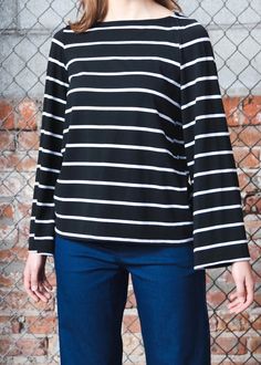 Inspired by a recent trip to France, the Breton Top or marinière, always takes us back to walking down Av. Kléber. Also influenced by its nautical beginnings, this striped top is a common KF go-to. Boat neck, stretch modal body, bell sleeve. Loose through body and hem hits at waist. 62% Rayon, 19% Cotton, 13% Modal, 6% Spandex. Slips on. Made in USA. Model is wearing XS. Need help with sizing? Size Guide Sailor Style Striped Long Sleeve Top, Striped Sailor Long Sleeve Top, Sailor Striped Long Sleeve Top, Striped Sailor Style Top For Spring, Spring Sailor Striped Top, Crew Neck Top With Striped Collar For Work, Crew Neck Top With Contrast Stripes For Work, Crew Neck Tops With Striped Cuffs For Work, Breton Top