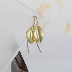 These unique hammered gold leaf earrings are handmade of yellow 14k solid gold. The leaves have a delicate texture formed as I was hammering the gold to give them their leaf shape. Each leaf is unique, and you can instantly see they are made by hand. Their finish is matte with shiny edges. These lovely gold earrings have an organic feel, are light and easy to wear, and will look beautiful with any outfit. Silicone ear backs are included for safety. Leaf's size is approx. 10 x 15.5 mm = 0.4 x 0.6 inch Earrings total length is: approx. 32 mm = approx. 1.25 inch * The earrings will be packed in a gift box ready to give as a gift, and shipped via Express mail service which usually takes 4-6 business days to arrive. * To see more gold earrings click here:  http://www.etsy.com/shop/SigalGerson?s Yellow Gold Leaf-shaped Brass Earrings, Yellow Gold Leaf-shaped Earrings For Pierced Ears, Yellow Gold Leaf Earrings, Minimalist Gold Leaf Earrings, Leaf Earrings Gold, Unique Handmade Earrings, Earrings Nature, Real Gold Jewelry, Gold Leaf Earrings