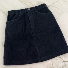 Brandy Melville Black Corduroy Mini Skirt One Size Never Worn Black Mini Denim Skirt For Fall, Black Cotton Mini Skirt For Fall, Black Cotton Mini Skirt For Winter, Black Cotton Short Skirt, Black Cotton Mini Skirt With Lining, Malia Skirt Brandy, Cargo Skirt Brandy Melville, Brandy Melville Black Skirt, Brandy Melville Cara Skirt