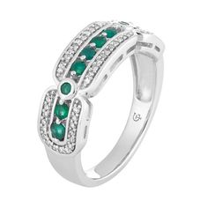 Elegantly appointed with rows of emeralds and diamonds, this unique 10k white gold ring complements your wardrobe in a uniquely stylish way. RING DETAILSWidth: 6.80 mmMetal: 10k white goldPlating: rhodiumFinish: polishedPackaging: boxedSTONE DETAILSStone type: emeraldTotal weight: 3/8 ct.Center stone size: 6 mm x 4 mmShape: ovalSetting: prongDIAMOND DETAILSTotal weight: 1/5 ct.Color grade: I-JClarity: I2-I3Shape: roundSetting: prongGemstones may have been treated to enhance their appearance. Spe Gold Cocktail Ring, Gold Cocktail, Right Hand Rings, Emerald Stone, White Gold Band, White Gold Ring, Emerald Ring, Ring Gold, White Ring