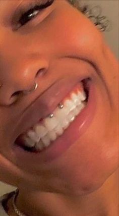 a close up of a person with a toothbrush in their mouth and smiling at the camera