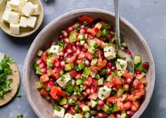 a bowl filled with cucumber, pomegranate and feta cheese