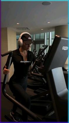 a woman is running on a treadmill with headphones