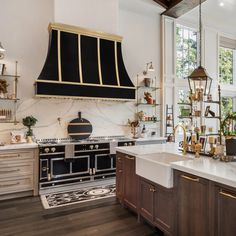 a kitchen with an oven, stove and sink in the center is decorated with gold accents