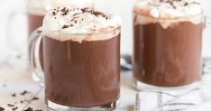 two mugs filled with hot chocolate and whipped cream