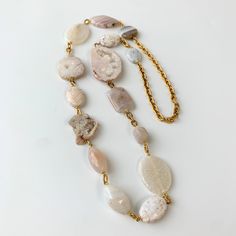 This entrance-making natural stone bohemian statement necklace is handcrafted with the intriguing Druzy agate with fascinating crystal matrix geode formation and various other types of white agate slices polished to a high gloss perfection. The alluring charisma of agate is due to the blend of physical and metaphysical properties of this natural stone. No two pieces of agate will ever be the same making each piece unique and One-of-a-Kind. This long bold boho agate statement necklace hosts a ric Agate Slice Jewelry, Hand-strung Long Agate Necklace, Hand-strung Agate Beaded Necklaces For Gifts, Elegant Hand-strung Agate Necklace, Luxury Agate Statement Necklaces, Halloween Charm Bracelet, Luxury Agate Statement Necklace, Long Statement Necklace, Rock Jewelry