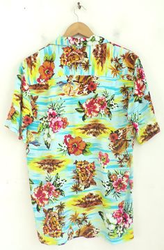 "-Description- >men's bright colored floral hula girl hawaiian shirt >collared >button front >open pocket on the front >size small >awesome print! >condition: excellent >color(s): multi >fabric(s): 100% rayon >care: machine wash -Measurements- >size: small ✩ all measurements are taken with the item laying flat & some sizes are estimates so please check measurements ✩ chest:42 \" / 107cm length: 28\" / 71cm shoulder to sleeve end: 10\" / 25cm shoulders: 18\" / Girls Hawaiian Shirt, Hawaiian Resorts, Floral Hawaiian Shirt, Resort Shirt, Vintage Hawaiian Shirts, Hula Girl, Vintage Hawaiian, Bright Colored, Fish Print