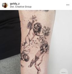 an arm tattoo with cherubs and flowers on it