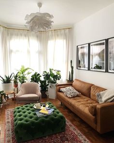 a living room filled with furniture and plants