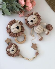 three stuffed animals sitting on top of a table next to flowers and a flower pot