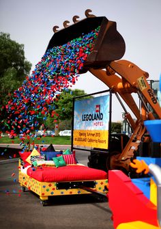 a large truck filled with lots of balloons and confetti on top of it